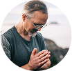 man with glasses meditating